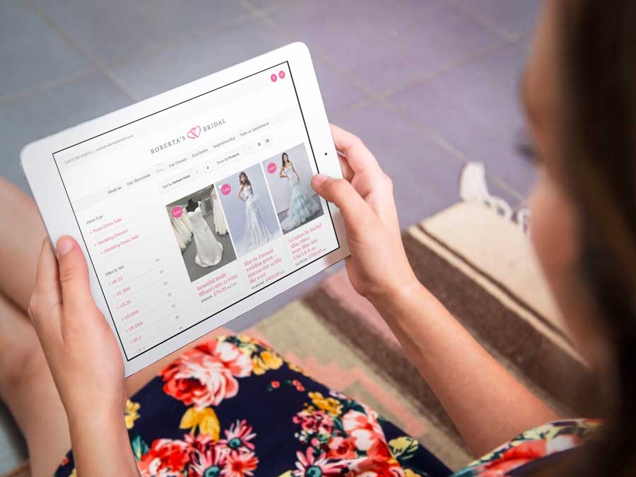 Woman looks at the Roberta's bridal website store on an iPad