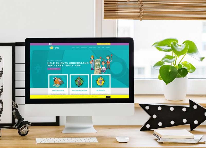 The Ignition! website homepage displayed on an iMac computer sat on a desk