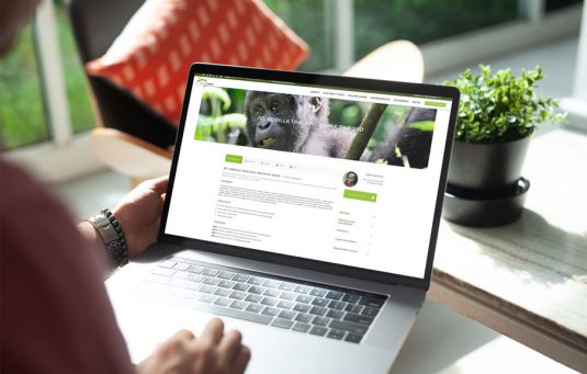 Venture Uganda gorilla tracking page displayed on a laptop computer