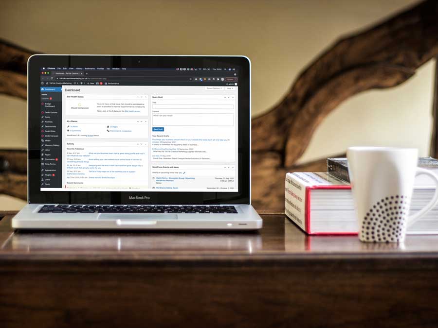 Wordpress dashboard on a macbook pro sat on coffee table Wordpress dashboard on a macbook pro sat on coffee table