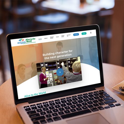 Alive to the World homepage design displayed on a computer screen